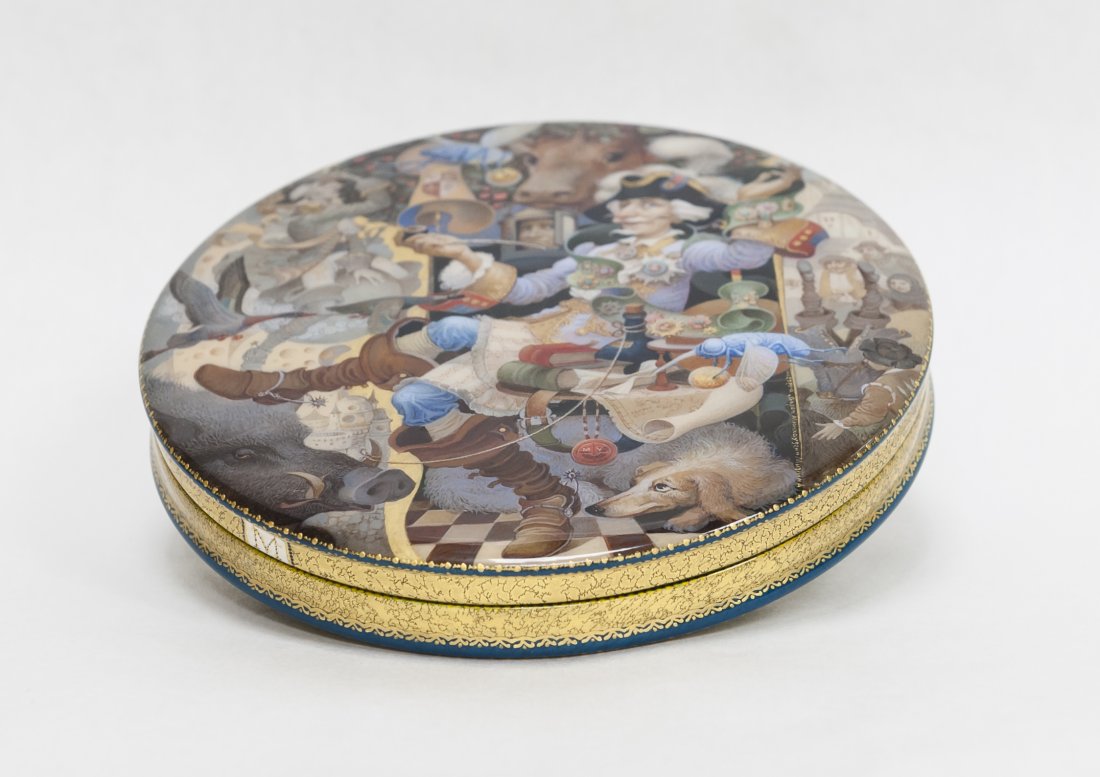 Mstera Russian Lacquer Box.: Very fine Mstera Russian hand painted lacquer box. Circular near flat form. The removable lid painted in intricated detail with adventures of Baron Munchausen . A full scale letter M fills the back si
