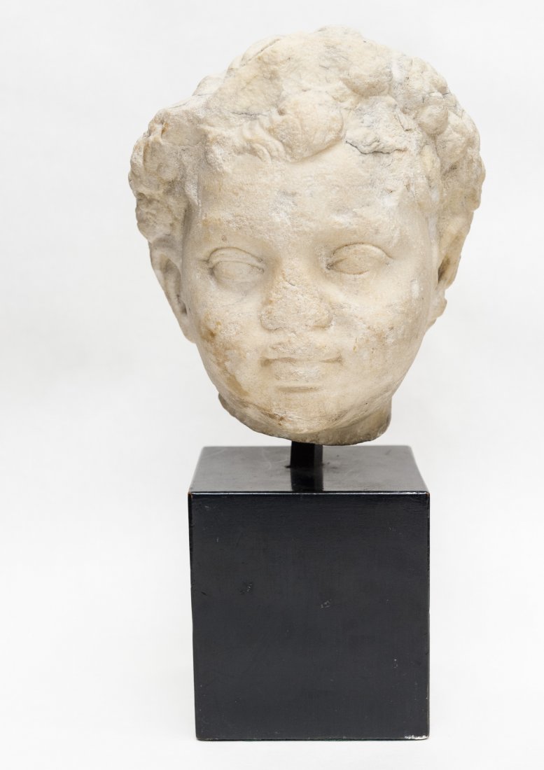 Ancient carved limestone head of a boy. (1 of 7)