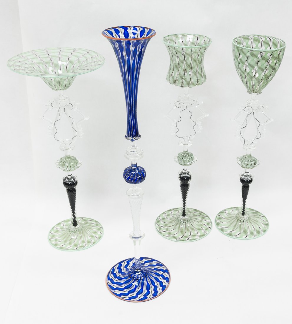 (4) Charles Savoie Zanfirico Art Glass Stems.: (4) Charles Savoie Zanfirico art glass stems. (3) light green swirl glasses with black twist stems and "lace" necks; Blue swirl champagne glass with white twist stem. (Approx. 17 1/4", 15 1/4", 15 1/4