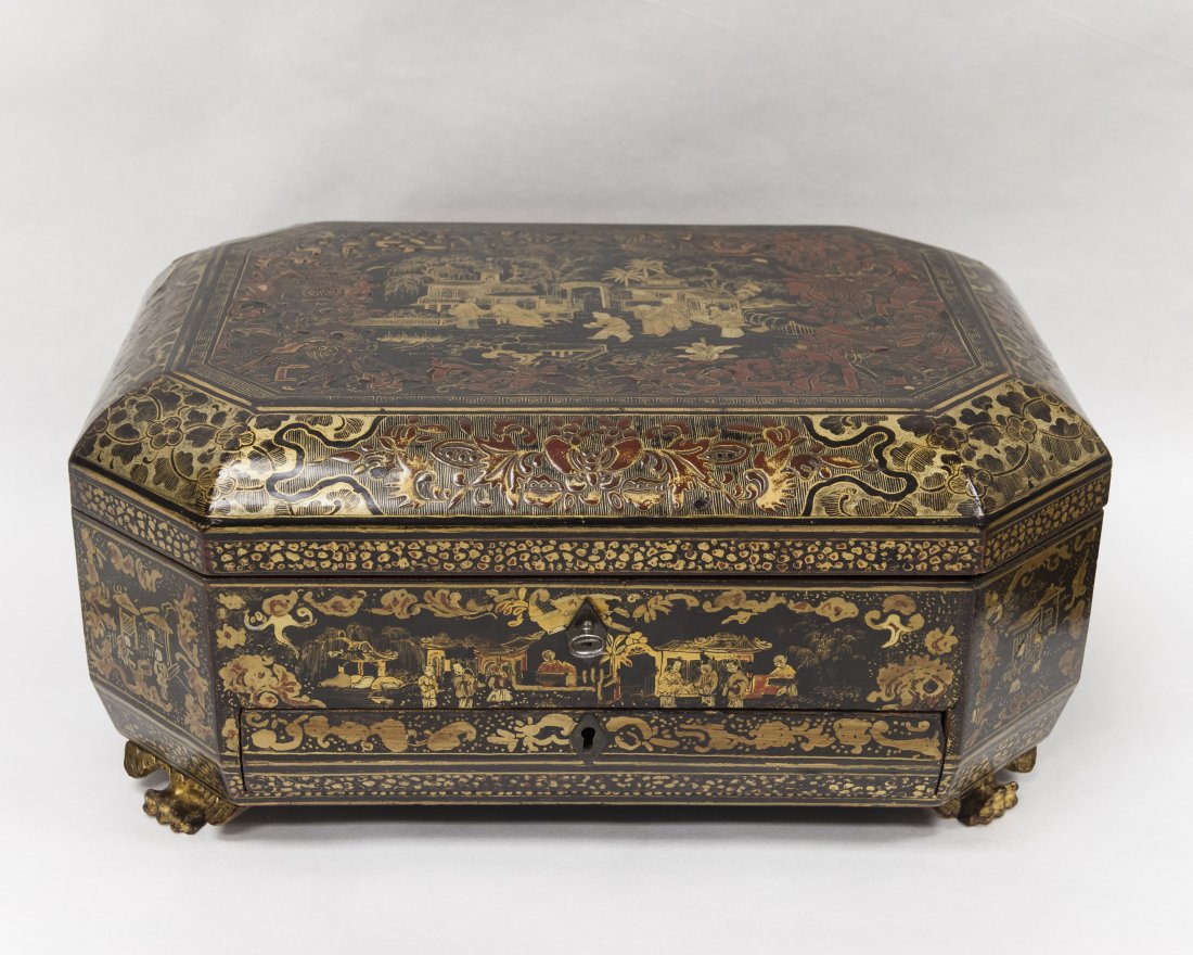 19th C. Chinese Export Lacquer Sewing Box.: 19th C. Chinese export lacquer sewing box. Black with red lacquer and parcel gilt casket form on winged bat feet, decorated overall with scenes of figures in pavilions and foliate borders. Hinged lid 
