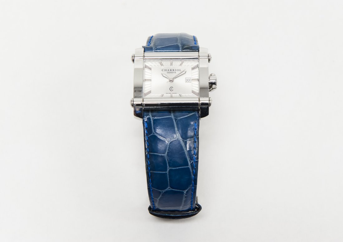 Charriol Swiss Made Wristwatch.: Phillippe Charriol wristwatch, squared stainless steel case with stick indicators and day aperture on a silver dial, lug stem, quartz movement. The case marked Swiss Made, Ref. CCHL 00398. On original