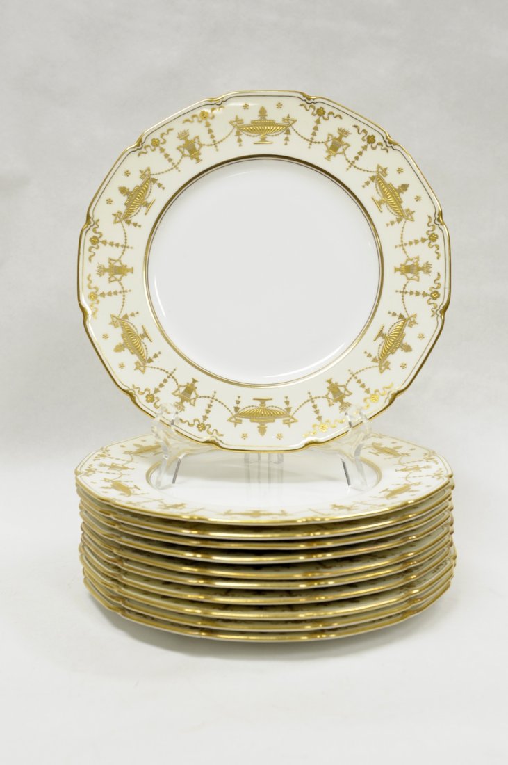 (11) Royal Doulton Gilt Embossed Dinner Plates.: Set of (11) Royal Doulton gilt embossed dinner plates. Neoclassical detail with scalloped edges. Royal Doulton maker's mark and stamped E. Keller & Sons, Allentown, PA. (Approx. 10 1/4" diameter).