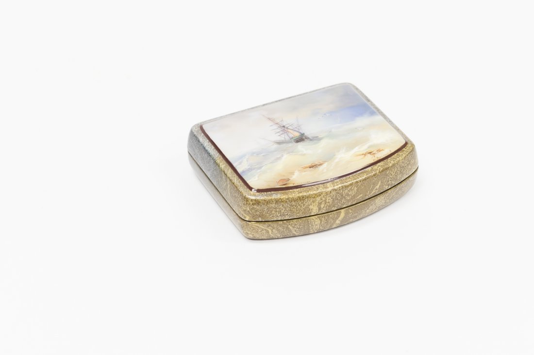 Valyalin Russian Fedoskino Lacquer Box.: Russian Fedoskino lacquer box. Titled ‘Ship in a Storm’. Painting depicts a ship being tossed in the waves of a storm. Body of the box is decorated with a swirling design in blues, purples and gol