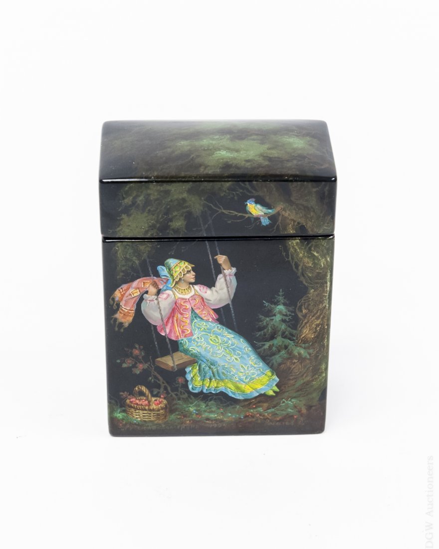 Fedoskino Russian Lacquer Box.: Fedoskino Russian lacquer box "Blue Bird". Depicts a young girl dressed in traditional Russian dress on a swing a basket of flowers sits by her side and her gaze is turned to the tree over head where 