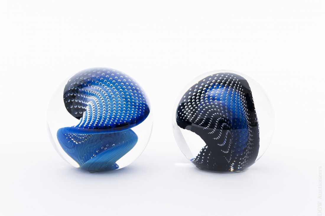 (2) Josh Simpson Iridescent Bubble Paperweights.: (2) Josh Simpson iridescent bubble paperweights in tones of black and blue. (Approx. 3" tall). From the collection of Eric Sinizer.