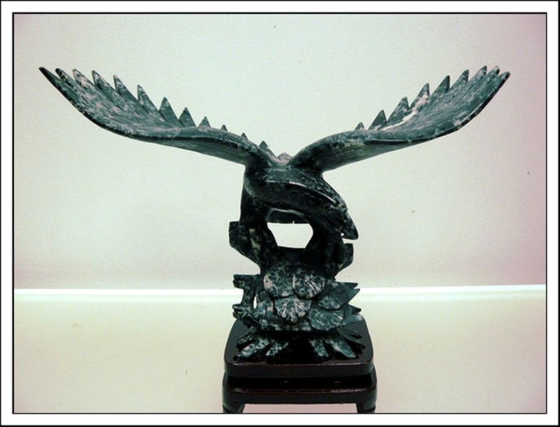 BLACK JADE EAGLE: Jade Eagle, Made From One Solid Piece Of Hard Black Jade. It Appears Black In Color With Some Spots Grey And White. It Is All Hand Carved.___Wide: 14", Deep: 6", High: 10".