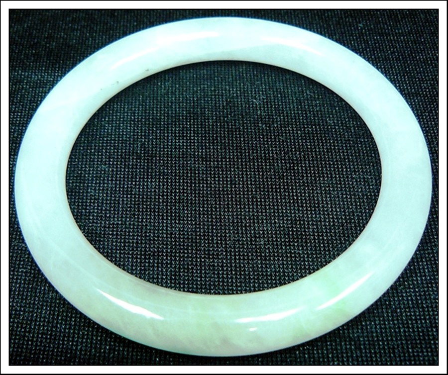 JADE BRACELET: JADE BRACELET - Diameter of the inside bracelet is 2 3/16"=5.6cm - Bracelet Is Made From One Solid Piece Of Natural Hard Jade. It Appears Light Green With Some Spots Dark Green. It Is Transparent. Wea