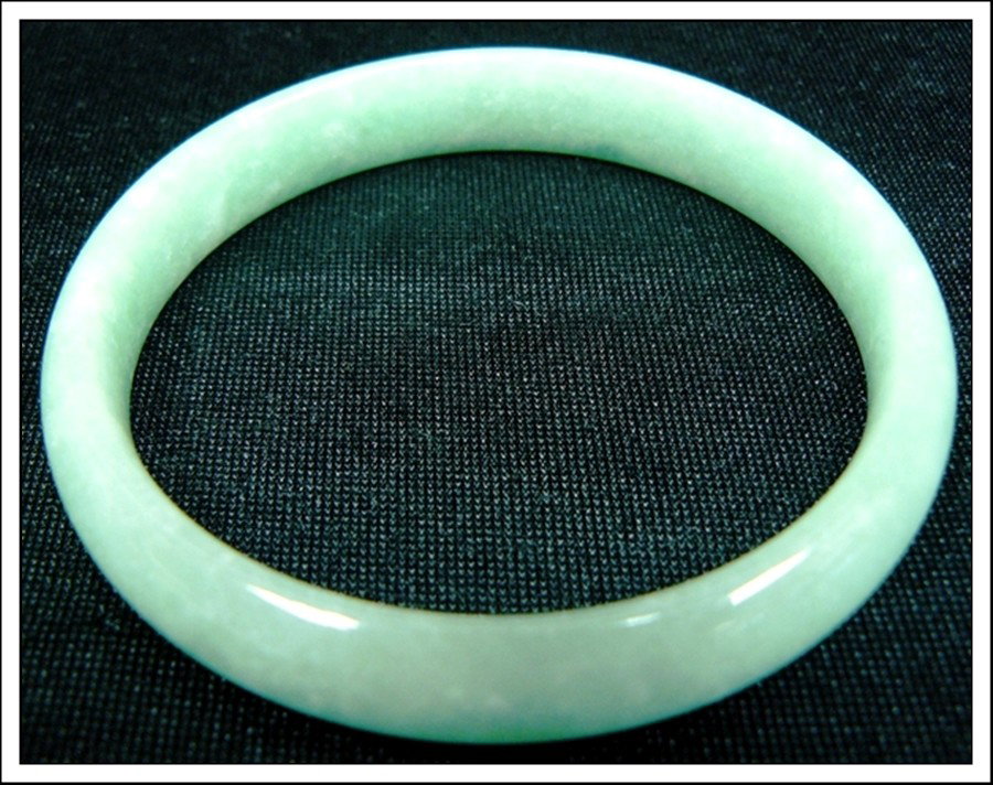 JADE BRACELET: JADE BRACELET - Diameter of the inside bracelet is 2 5/16"=6cm - Bracelet Is Made From One Solid Piece Of Natural Hard Jade. It Appears Light Green With Some Spots Dark Green. It Is Transparent. Weari
