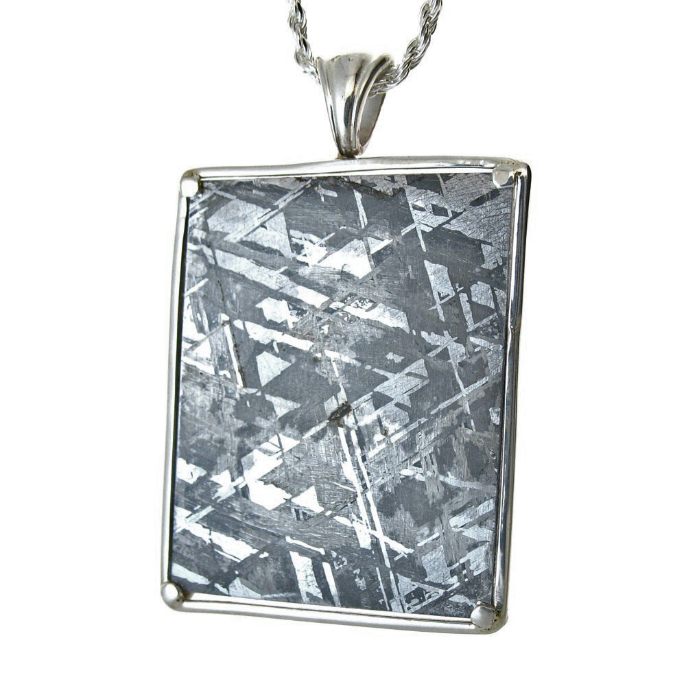 RECTANGULAR GIBEON METEORITE PENDANT: Measures: 1.90" Tall x 1.2" Wide - Metal: Sterling Silver Frame - First discovered in Namibia, Africa in 1836, the Gibeon meteorites come from broken asteroid fragments. Dating studies have placed the