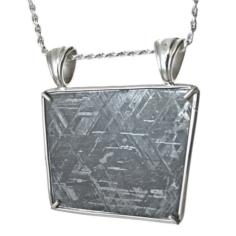 GIBEON METEORITE: Chain: Choose Necklace - Measures: 1.7" Wide X 1.75" Tall - Metal: Handcrafted Sterling Silver Frame - First discovered in Namibia, Africa in 1836, the Gibeon meteorites come from broken asteroid frag