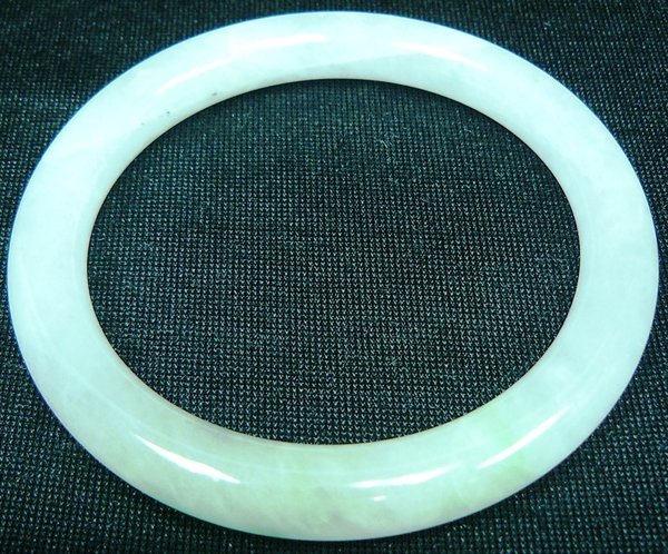 JADE BRACELET: JADE BRACELET - This Bracelet Is Made From One Solid Piece Of Natural Hard Jade. It Appears Light Green With Some Spots Dark Green. It Is Transparent. Wearing Jade Bracelet Is Believed To Improve Your