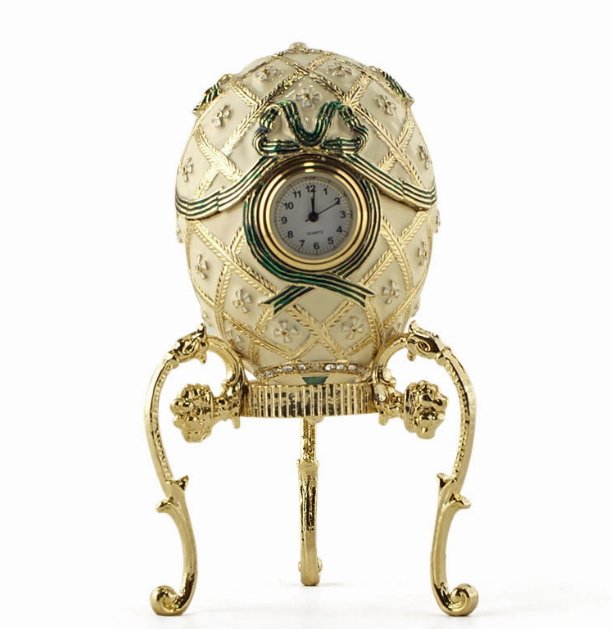 ORDER OF ST. GEORGE FABERGE STYLE EGG: Beautiful strawberry red, green and golden enamel colors are intervened to produce this Faberge egg. The golden framed quartz clock at the center is surrounded by a green ribbon. The egg opens up hori