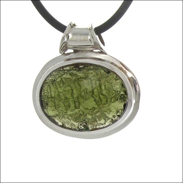 A FACETED AND POLISHED DESIGNER MOLDOVITE: A Faceted And Polished Designer Moldovite---metal: Sterling Silver Frame-stones: Moldovite - 26 Carats-measures: 1" Tall X 1.25" Wide-