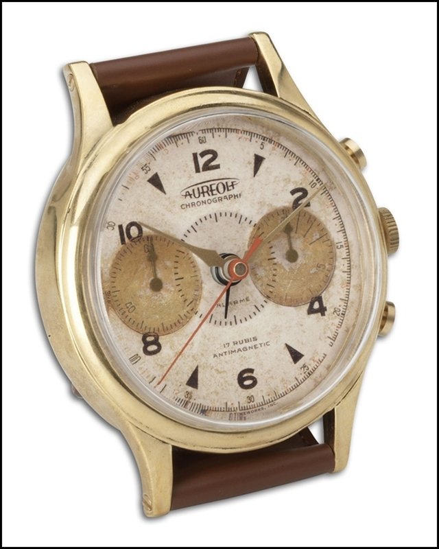 WRISTWATCH ALARM ROUND AUREOLE: Wristwatch Alarm Round Aureole - Material: Brass, Leather, Plastic, Aluminum - Overall Depth: 2 Inches - Overall Width: 3.25 Inches - Overall Height: 4.5 Inches - Weight: 1 Lbs. - Description: Brass R