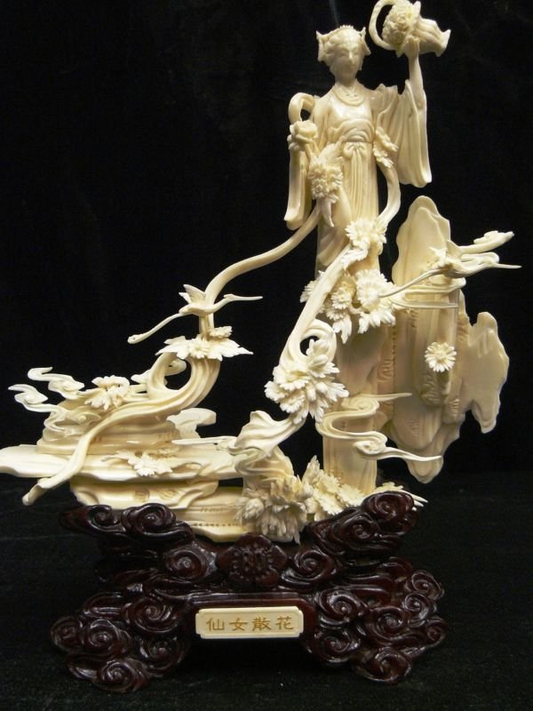 HAND CARVED BONE FAIRY: Hand Carved Bone Fairy - Wide: 8", Deep: 4", High: 12" . - This Beautiful Artwork Is Made From Cow Bones. A Fairy Is Carved On A Mountain. All Natural And All Hand Carved From One Solid Piece Of Bone.
