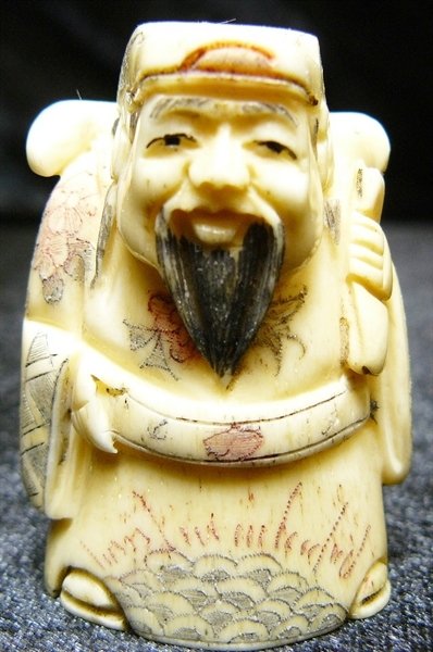 2" BONE NETSUKE: 2" Bone Netsuke - 1.5"x1"x2" - this is a very beautifully carved netsuke. All Hand Carved From One Solid Piece Of solid bone. Hand Painted With Signature On The Bottom. There Are 2 Holes On The Back, 