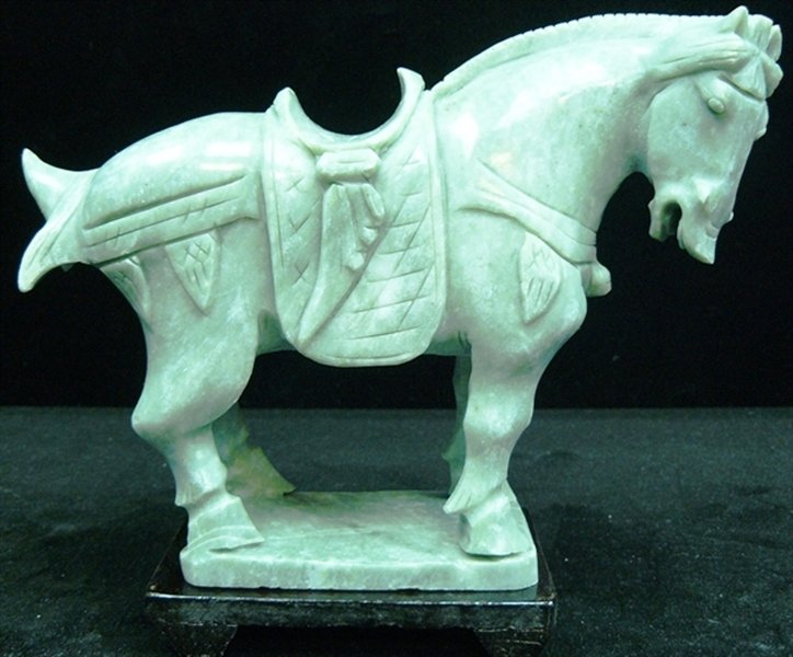 REAL JADE SADDLED TANG HORSE: Real Jade Saddled Tang Horse - L: 7", W: 3", H: 6" - This Horse Is Made From One Piece Solid Taiwan Jade. It Appears Light Green With Some Area Dark Green. It Comes With A Wooden Base