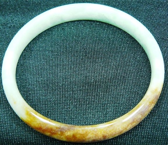 JADE BRACELET: Jade Bracelet - Diameter Of The Inside Bracelet Is 2 5/16"=6cm Sold Out - This Bracelet Is Made From One Solid Piece Of Natural Hard Jade. It Appears Light Green With Some Spots Dark Green And Brown. 