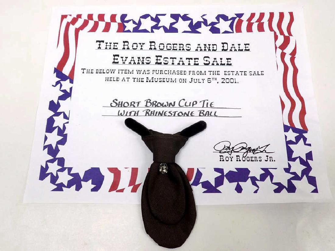 ROY ROGERS OWNED WARDROBE COWBOY TIE Legendary Cowboy: Legendary Cowboy Western Television Star Roy Rogers owned personal Short Brown Clip Cowboy Tie with Rhinestone Ball. Comes with Certificate of Authenticity from The Roy Rogers and Dale Evans Estate Sa