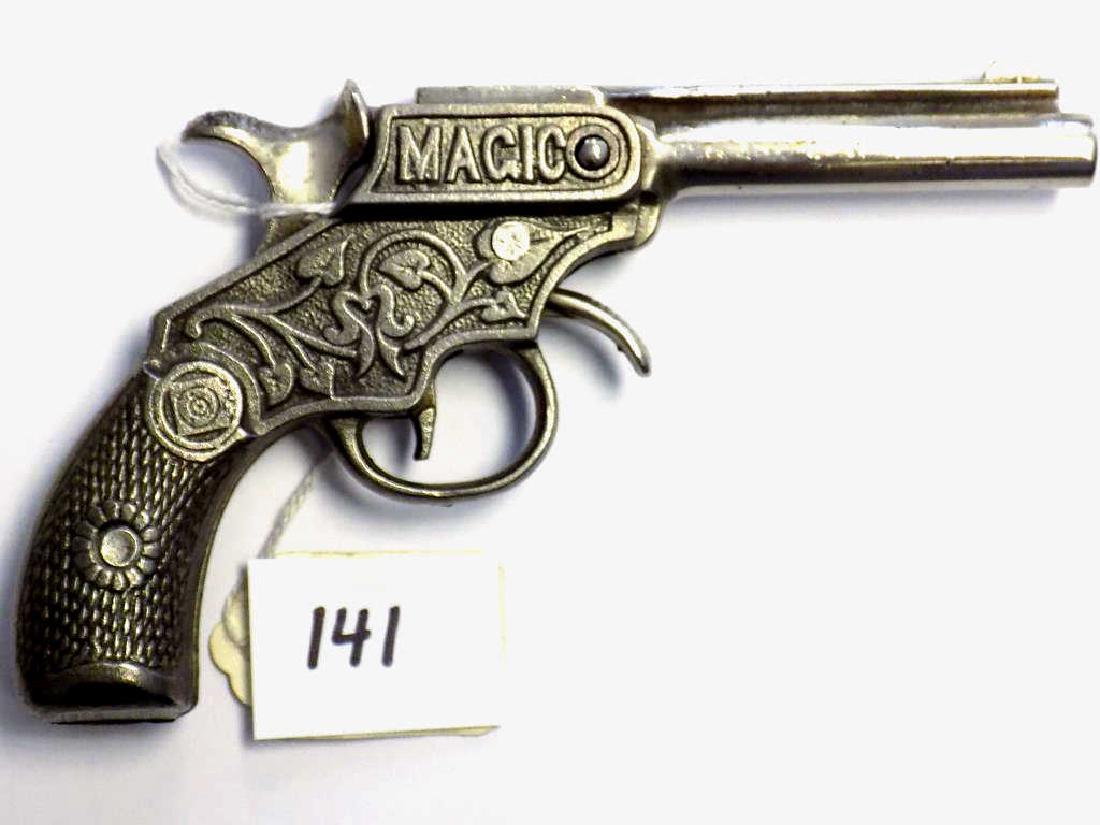 KENTON MAGIC 1900 CAST IRON CAP GUN PISTOL Kenton Magic: Kenton Magic Early 1900 Cast Iron cap gun toy model of a .22 Caliber Blank pistol. Ornate casting with spaded foilage. Working order. Nice condition, nice patina. Length 6 1/4"