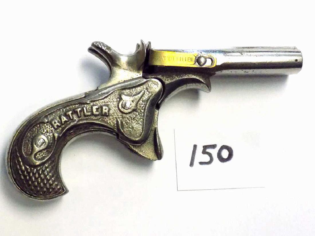 RARE 1881 RATTLER DOUBLE BARREL CAST IRON CAP GUN Rare: Rare Rattler Double Barrel Cast Iron Cap gun pistol patentted Feb 1881 with engraved brass. Ornate cast handle with scrollwork. Noted in the Best Cast Iron Toy Pistols 1870-1940 maker unknown. Working
