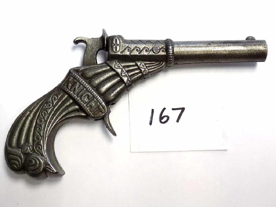 STEVENS KNIGHT CAST IRON CAP GUN PISTOL Stevens Knight: Stevens Knight Cast Iron Cap gun pistol. Patented in 1878. Very Fancy casting. Working order, Very nice condition. Rated 4 Stars by Logan & Best. Length 5". With Original Copper Advertising Print Bloc