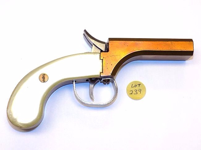 DOUBLE BARREL DERRINGER BRONZE CAP GUN PISTOL: Antique Double Barrel Derringer Bronze cap gun pistol. Pearloid grips. Steel hammers, trigger & finger guard. Serial # 1205. Maker unknown. Working order. Length 7"