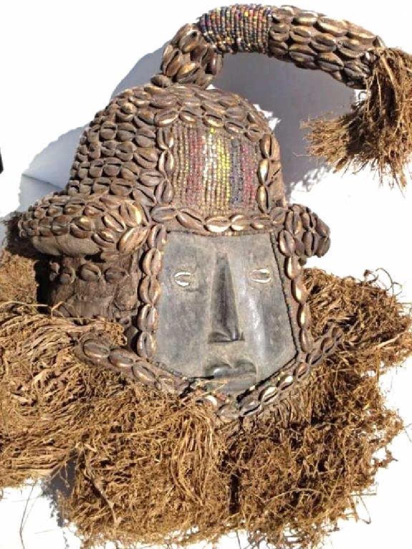 AFRICAN CENTRAL CONGO CARVED HEAD DRESS Antique African: Antique African Central Congo ceremonial head dress. Carved wood with beads, conch shells . H 18" x L 12".