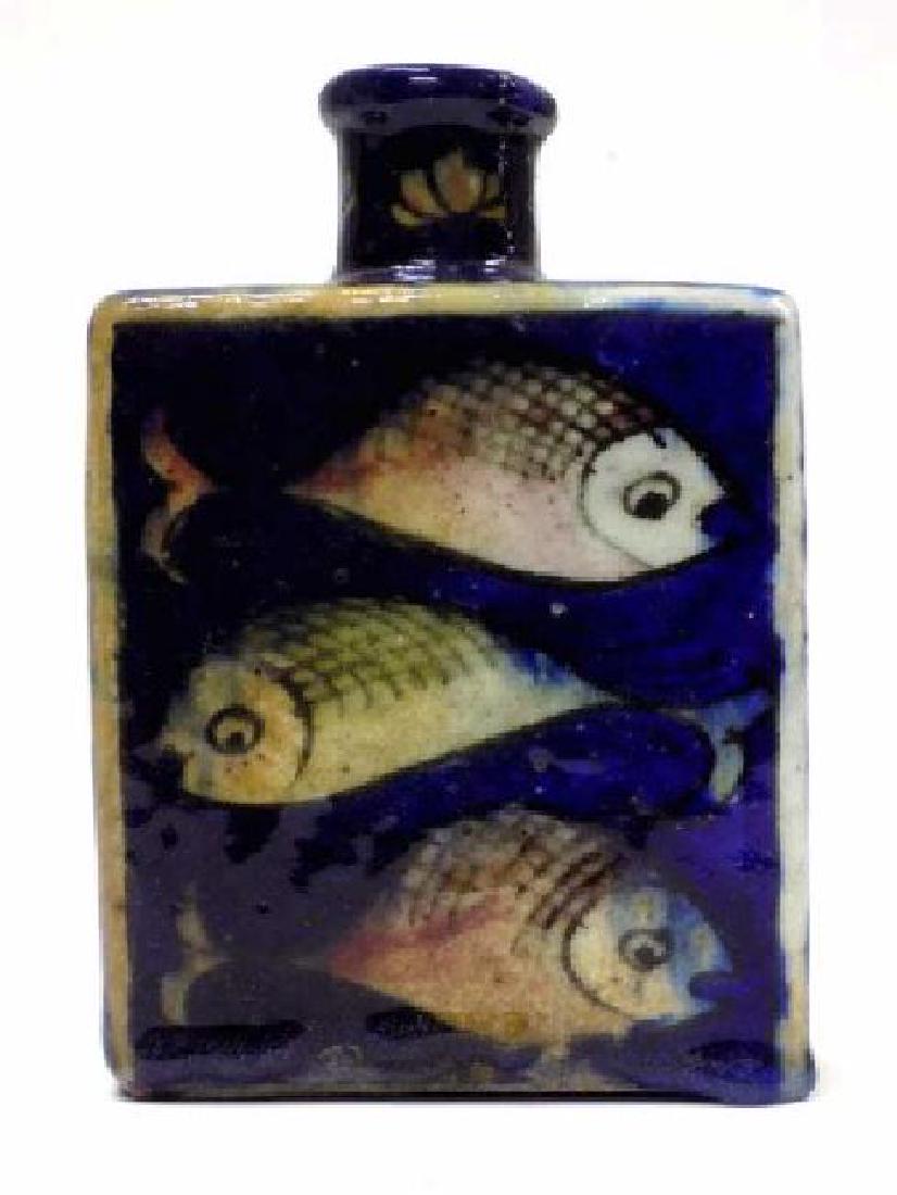 19TH CENTURY PERSIAN FISH DECORATED POTTERY FLASK: 19th Century Persian glazed decorated pottery flask. Depicting swimming fish and Flora with cobalt blue background. Height 4 1/4" x Length 6".