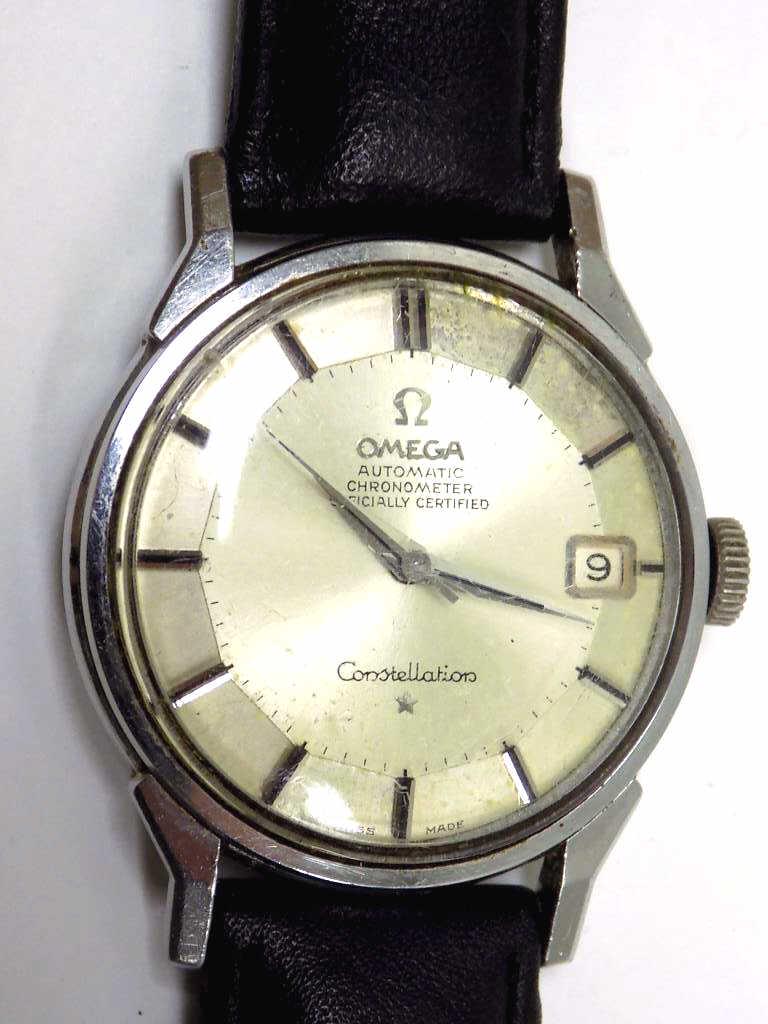 OMEGA CONSTELLATION CHRONOMETER WRISTWATCH: 1960's Omega Automatic Chronometer Constellation. Officially Certified Men's Wristwatch. 24 Jewel Swiss Movement. Golden Face with Chrome Silver Hands and Markers. 34mm Case. Logo Back. Genuine Black 