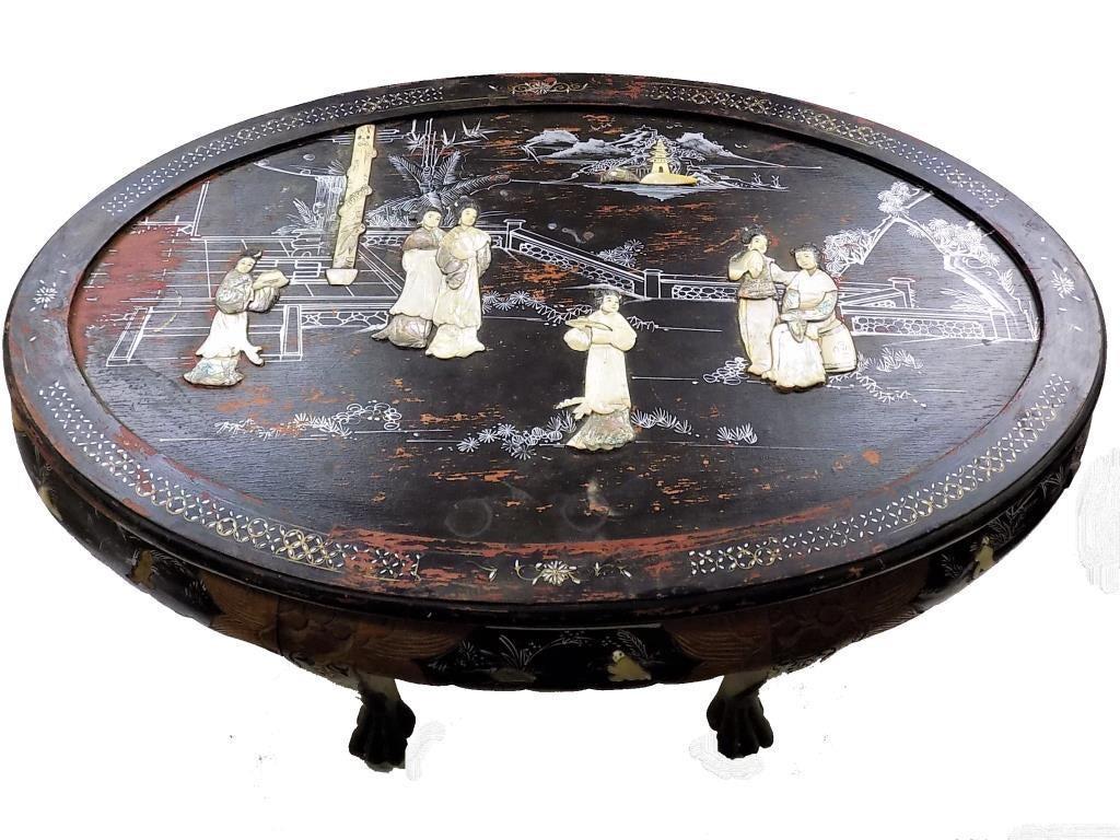 CHINESE CHINOISERIE INLAY NESTING TABLE CHAIR SET: Chinese Chinoiserie Lacquered Nesting Table 6 Chair Set. Oval Form with Surrounding Scenes Inlaid with Bone, Mother of Pearl and Abalone. Carved Paw Feet. 48" x 32" x 21" Minor losses.