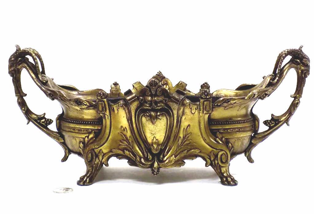 RENAISSANCE REVIVAL GILT BRONZED CENTERPIECE: Circa Late 1800's Renaissance Revival Gilt Bronzed Metal Centerpiece. Mythological Design with Center Bachus Extending Into Dual Ram Head Handles with Paw Feet. Inner and Outer Scrollwork and Acanthus