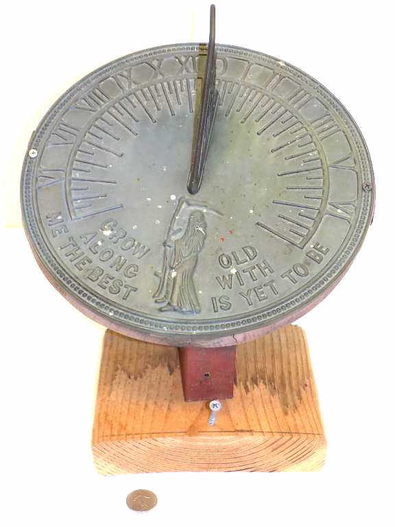 CHARMING FATHER TIME BRONZED SUN DIAL: Charming Bronzed Sun Dial. Reads: Grow Old Along With Me The Best Is Yet To Be. Father Time Depicted. Diameter 11". Height 10" on Mounted Wood Base.