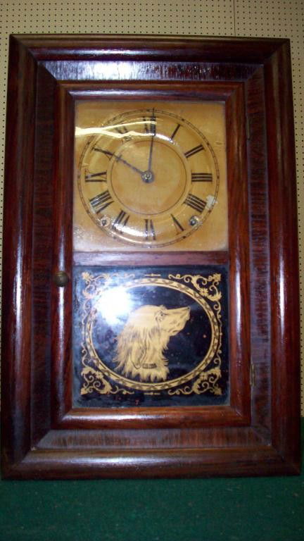 SETH THOMAS CO. CT SHELF CLOCK: Seth Thomas Co. Connecticut. 19th C. Mahogany shelf clock. Original glass & eglomise setter dog panel. S & T logo clock hands. Brass pendulum & key. not running. H 16 1/2"" x L 11"" x W 4"".