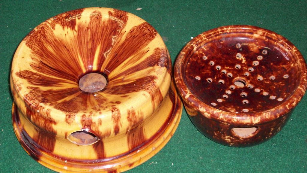19TH CENTURY ROCKINGHAM WATER DISPENSERS: 2 19th Century Rockingham brown & yellow spatterware water dispensers. H 3 1/2"" x D 8"" & H 3 1/4"" x D 6"". Larger has 2 Approx 1 has 2 approx 1"" hairlines.