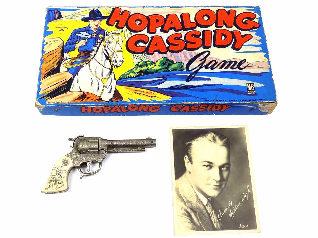 HOPALONG CASSIDY GAME CAP GUN & PHOTOGRAPH: Vintage 1950 Milton Bradley Hopalong Cassidy Board Game. Vibrant Graphics on Original Box with Game Board and Pieces. Along with a 1950's Wyandotte Toy Cowboy Gun / Pistol (As is) & Photograph