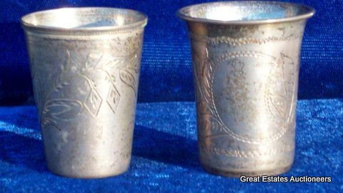 RUSSIAN SILVER BEAKERS - SHOT GLASSES: 2 Russian silver Kiddish beakers / shot glasses / jiggers. Etched scrolls & foilage cartouches. 84 silver & Head maker marks. H 1 1/2"" x W 1""