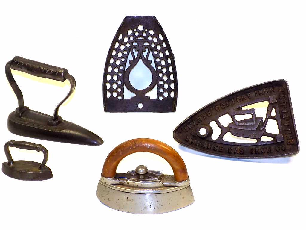 RARE PRIMITIVE CAST IRONS GROUP: 19th Century Primitive Cast Irons Group. Including 3 Rare Miniature Irons including Wood Handle Sad Iron, I Want U Comfort Advertising Iron Trivet Sracuse Gas Iron Co. Philadelphia PA USA, Urn Decorat