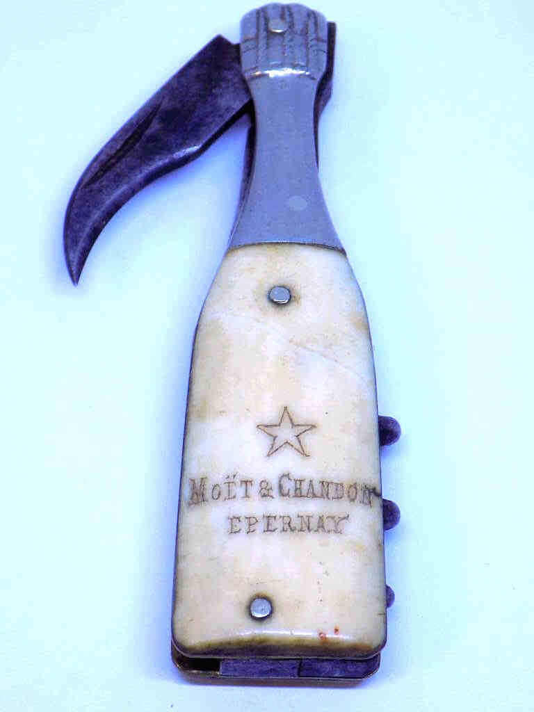 MOET & CHANDON EPERNAY BOTTLE FORM CORKSCREW KNIFE: Rare Moet & Chandon Epernay Advertising Corkscrew Bottle Opener Dual Blade Knife. Bottle Form with Steel neck and Bone Handle. Height 3 1/4"