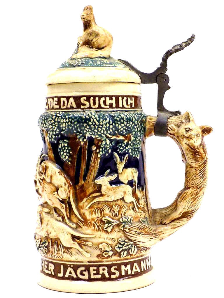 ANTIQUE GERMAN FOREST ANIMALS SAYINGS BEER STEIN: Antique German Forest Animals Pottery Beer Stein. Fox Form Handle, Squirrel Lid Finial, Stag, Hunting Scene with Hounds and Deer. Old German Saying. Height 8.50". Base Signed Germany 11205