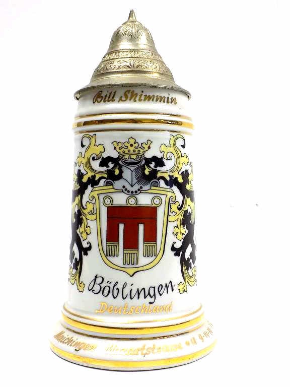 AMERICAN COLD WAR MILITARY REGIMENTAL BEER STEIN: American Cold War Military Regimental Beer Stein. Made in Germany Circa 1950's. Issued to Bill Shimminl. Gold Gilt Decorated Porcelain with Crowned Armor Crest and Fancy Pewter Lid. 1/2 Liter with Nud