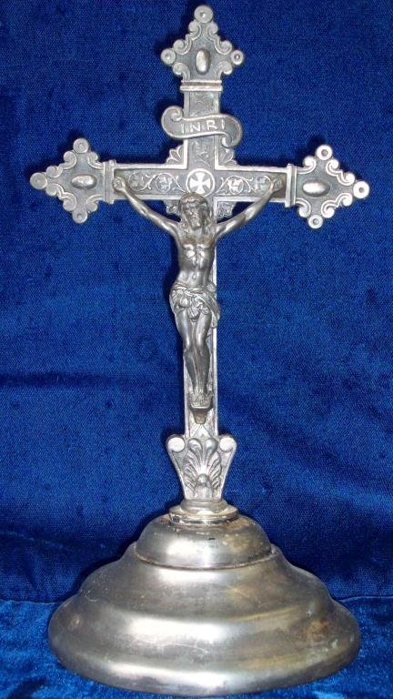 JESUS CRUCIFIXION SILVER CROSS STATUE: Early 1900's. Jesus crucifixion religious patinized repousse engraved silver alloy sculpture on turned saucer base. H 10 1/2" x D 5".