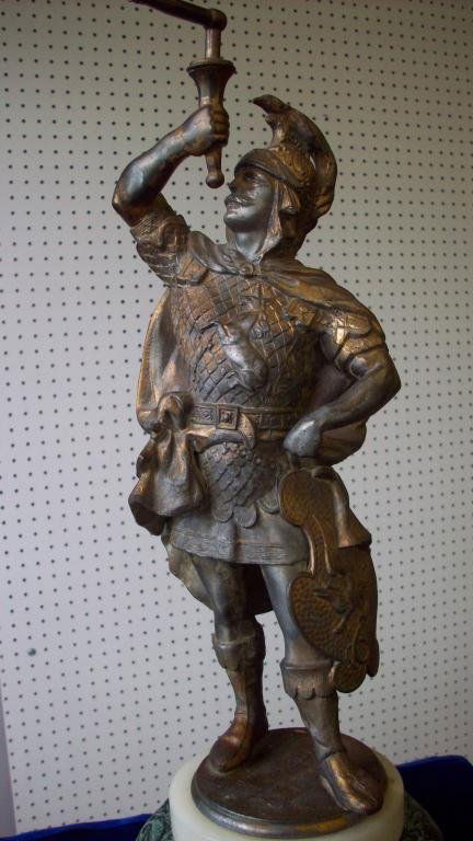 MEDIEVAL GLADIATOR GILT METAL STATUE: 19th Century gilt metal statue of a standing warrior in battle uniform adorned with neolithic griffins,birds & unicorn. Alabaster atop faux marble painted bronzed spelter base. Condition: rubbed gilt