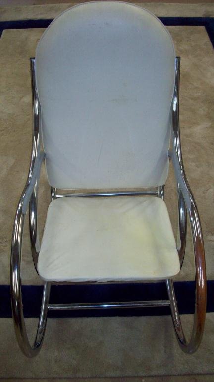 MIDCENTURY MODERN WHITE ROCKING CHAIR: Midcentury Modern padded white vinyl & chrome rocking chair . H 40" x L 42". Condition: vinyl needs cleaning.