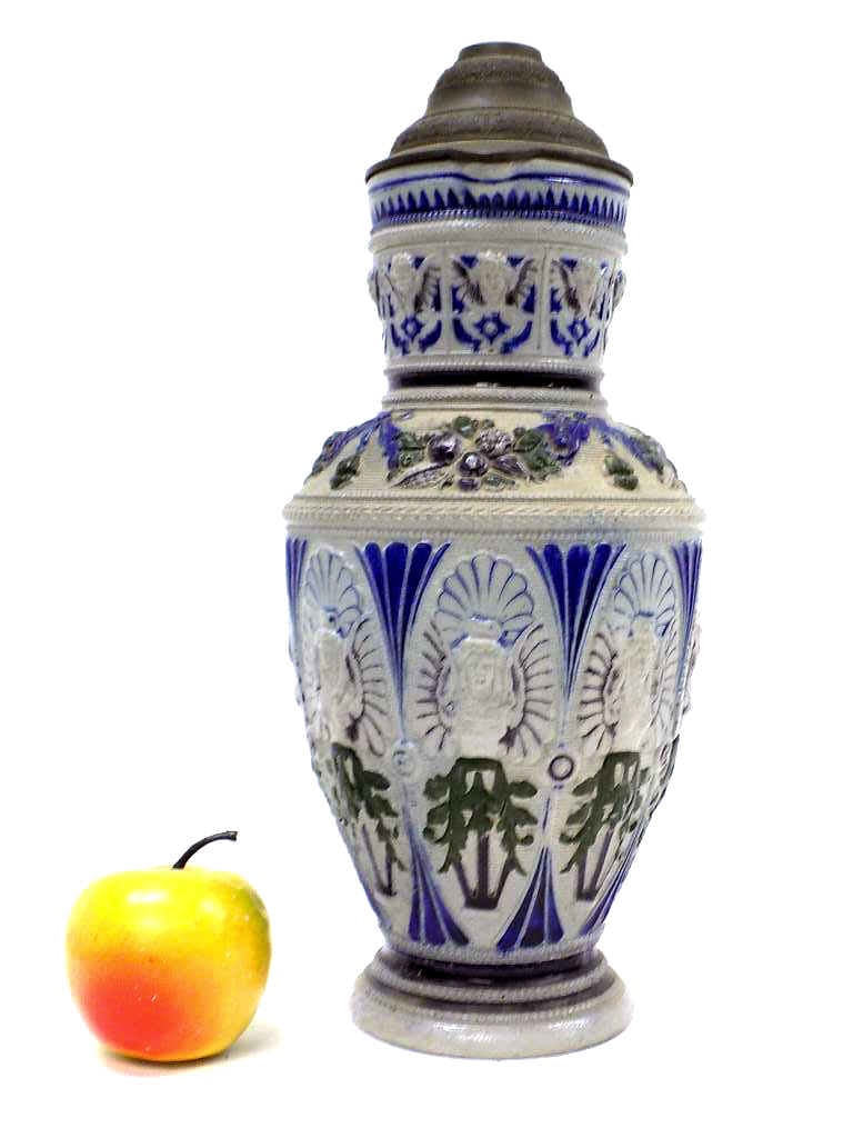 GERMAN STONEWARE ALLEGORIC BEER STEIN: Antique German Beer Stein Tankard. Blue and Green Decorated Stoneware with Surrounding Allegoric Angels and Putti. Pewter Lid. Numbered 675. Height 13.50" ref 1039