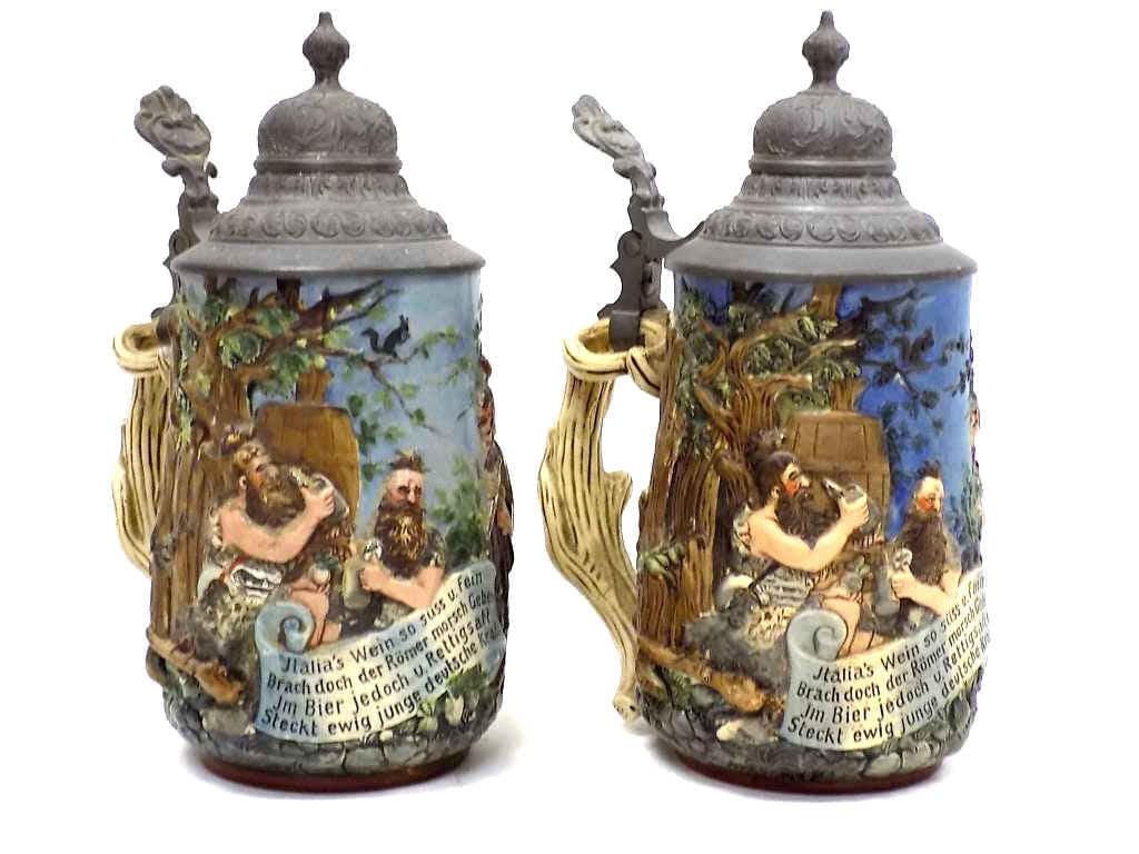 PAIR REINHOLD HANKE GERMANS ROMANS BEER STEINS: Pair of Late 19th Century Rare Reinhold Hanke German Relief Pottery Steins No. 1268 Entitled Germans And Romans. Gesetzlich Geschutzt Base Marks. Designed After The 1890 Illustration by Heinrich Schli