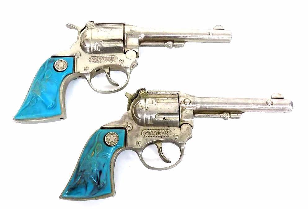 1950'S WESTERN COWBOY TOY CAP GUNS TURQUOISE GRIPS: Pair Hubley 1950's Western Cowboy Die Cast Toy Cap Guns. Turquoise Plastic Grips with Texas Longhorns. As is 2nd Gun missing part of trigger.