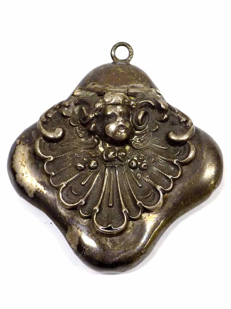 RENAISANCE REVIVAL STERLING SILVER SECRET LOCKET: Renaisance Revival Sterling Silver Secret Locket. Cupid Head on Scrolled Shell Lifts to Reveal Secret Compartment. Antique Baby Photo and Locket of Hair Inside. Rear Marked Sterling with Indiscernable