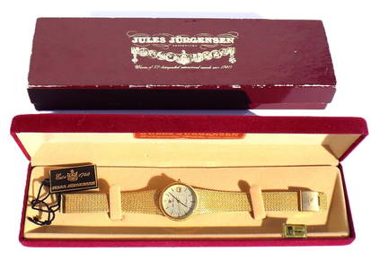 JULES JURGENSEN GOLD TONE MEN'S WRISTWATCH: Vintage Jules Jurgensen Gold Tone Men's Wristwatch. Quartz Movement with Diamond Chip Face & Date Display. Adjustable Bracelet. With Original Boxes, Tag & Papers. Length 8.50" Excellent condition, nee