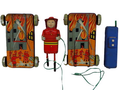 VINTAGE 1950'S JAPANESE TIN TOY FIREMAN: Vintage SKK Japanese Tin Toy Fireman with Tin Lithogrraph Wheeled Bases and Remote Control. Depicting Firemen Fighting a Fire. Fireman Height 6.50" Display piece, wire unattached.